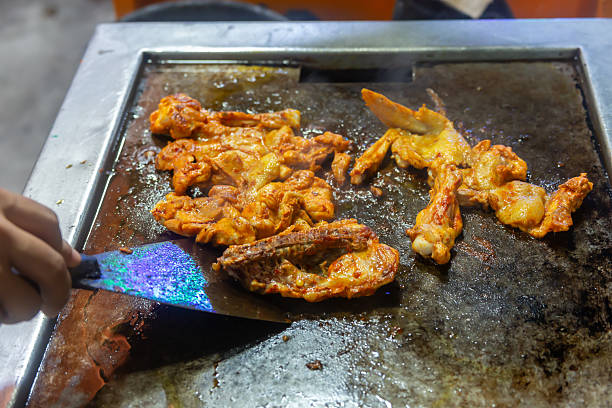 istock A person is cooking chicken on a grill 2250532786