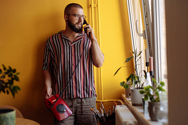 istock Man on a phone in a bright yellow room 2250538628
