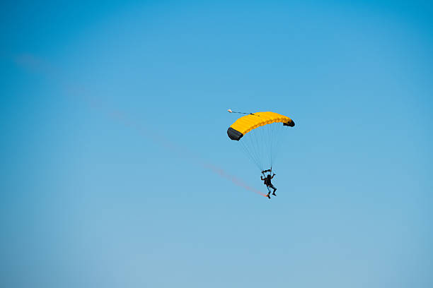 istock Parachutist on the background of blue sky 2250539773