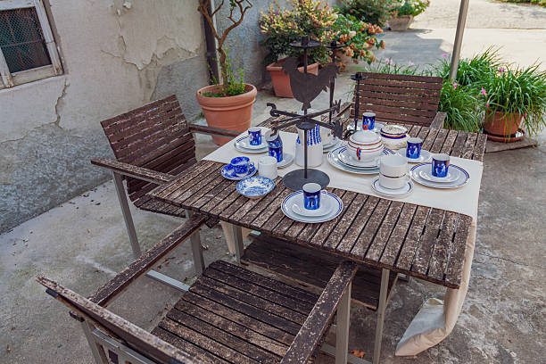 istock Rustic wooden table and chairs with vintage tableware for an outdoor breakfast or coffee 2250542226