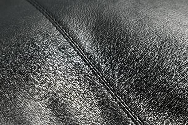 istock Black natural leather with seams as background, closeup view 2250542703