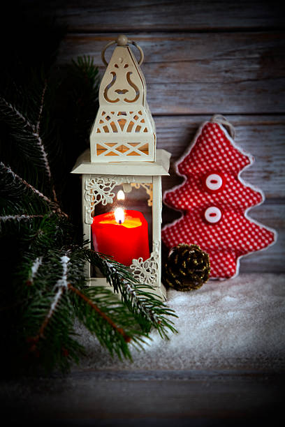 Burning lantern and Christmas decoration on wooden rustic background