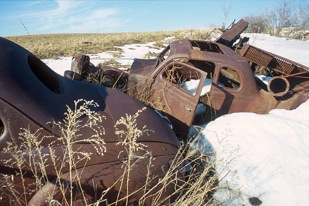 Ponoka County, Canada - January 28, 2007. Outdoor scene showing the wreck of a classic automobile rusting away in the countryside of Alberta, Canada.