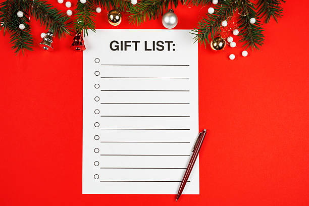 istock Christmas gift list. Top view on a vibrant red background. 2250553889