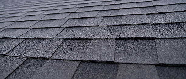 istock Selective focus texture of dark gray asphalt roof shingles 2250554844