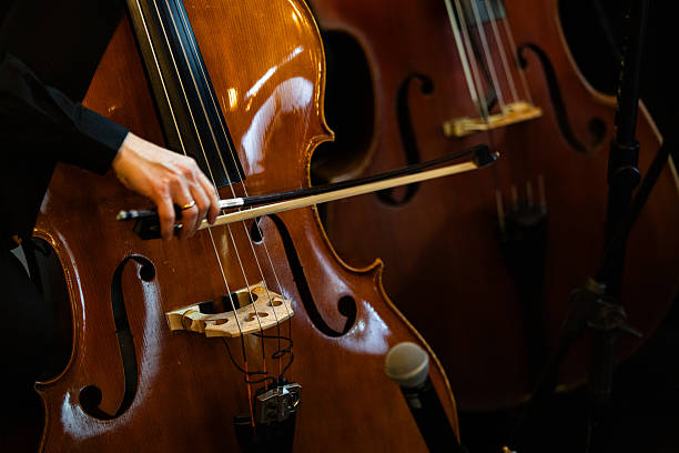 istock Musician Playing Cello On Dark Stage Close Up 2250556627