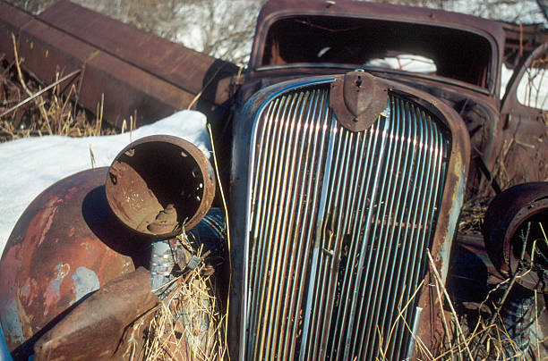 Ponoka County, Canada - January 28, 2007. Outdoor scene showing the wreck of a classic automobile rusting away in the countryside of Alberta, Canada.