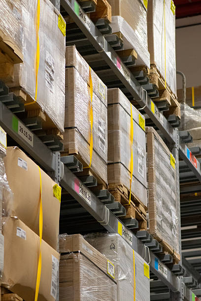 istock Modern industrial warehouse interior with tall shelving and stacked pallets 2250562759