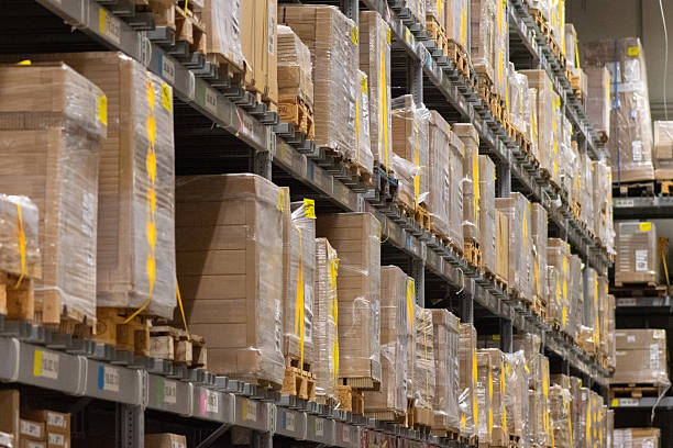 istock Modern industrial warehouse interior with tall shelving and stacked pallets 2250562784