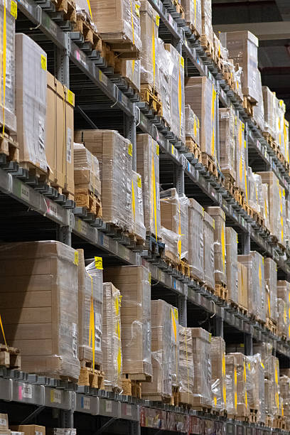 istock Modern industrial warehouse interior with tall shelving and stacked pallets 2250562799