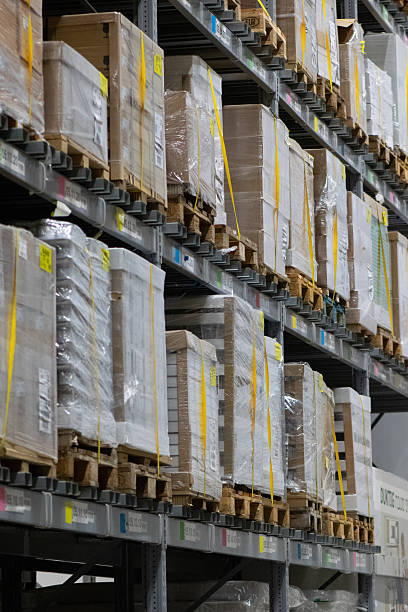 istock Modern industrial warehouse interior with tall shelving and stacked pallets 2250563007