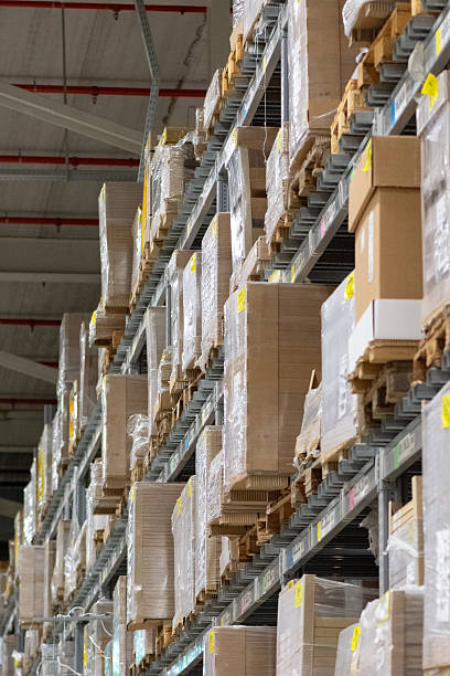 istock Modern industrial warehouse interior with tall shelving and stacked pallets 2250563090