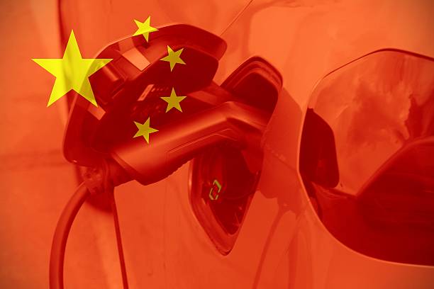 istock Electric car charging by a Chinese flag 2250565634