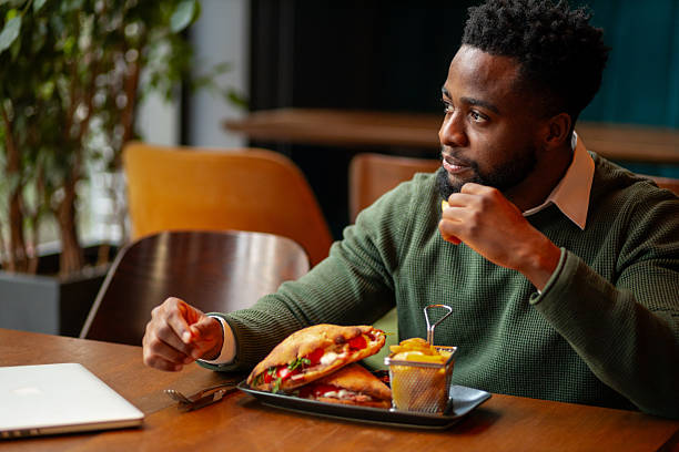 istock Young man enjoying lunch break in cafe 2250565679