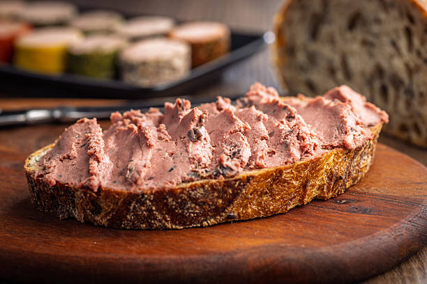 istock Pate on a slice of bread on wooden table. 2250567341