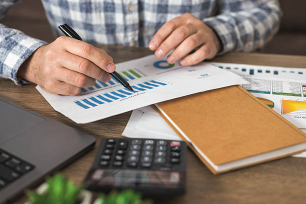 istock Businessman analyzing financial charts at office desk 2250576319
