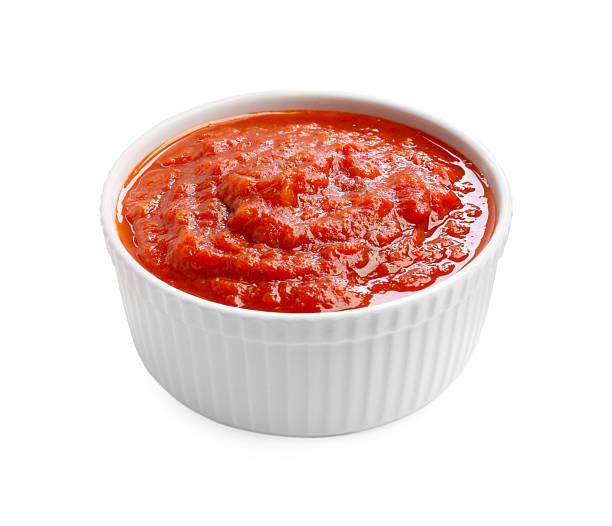 istock Homemade tomato sauce in bowl isolated on white 2250576499