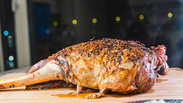 istock Roast Lamb Leg with Side Dishes on Board 2250579505