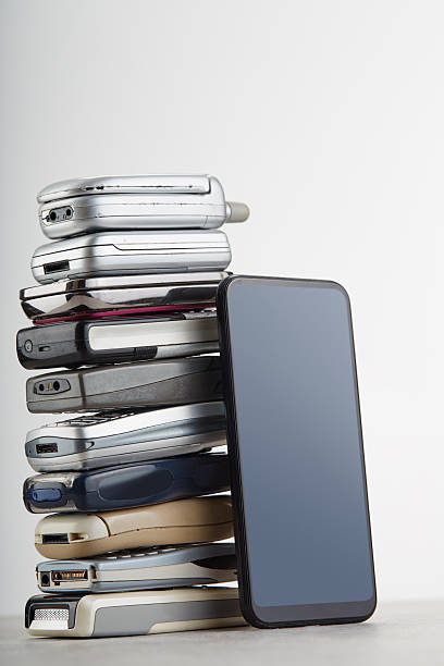 istock Stack of various old mobile phones, pusbutton and flip models, stacked on top of one another, with a modern smartphone e-waste concept 2250581493