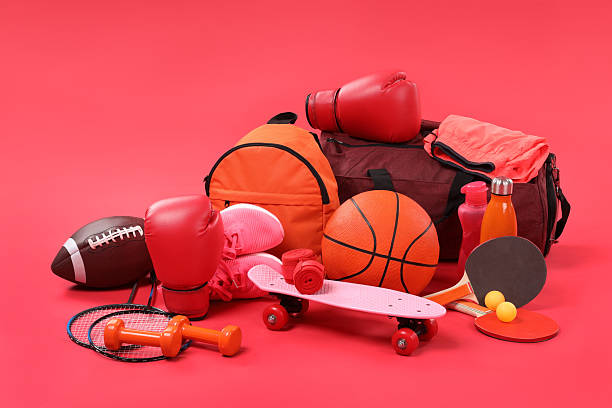istock Many different sports equipment on red background 2250586965