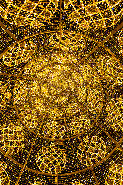 view from inside a lit-up Christmas tree located on the city streets