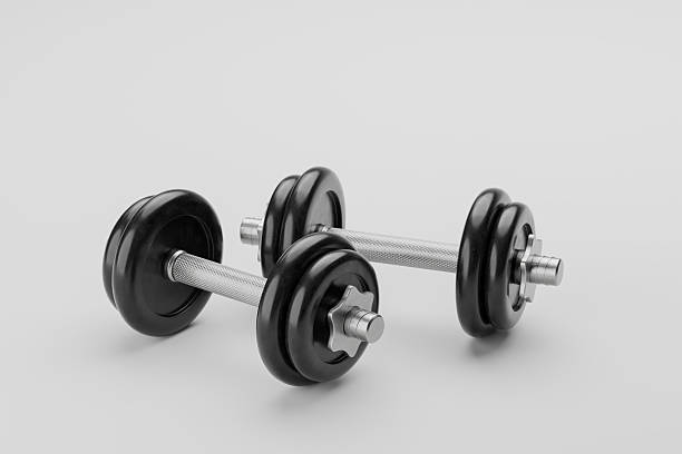 istock Pair of black adjustable dumbbells on a light gray background. 2250588313
