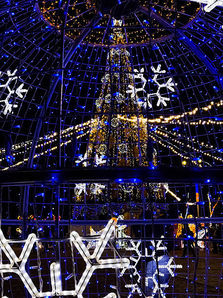 istock Festive night scene showing a brightly lit Christmas tree seen through a glowing light sphere 2250590144