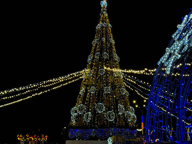 istock Large Christmas tree and glowing light sphere in a festive outdoor display at night, with decorative LEDs 2250590147
