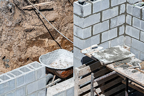 Home improvement new in-law apartment addition basement concrete block masonry walls are being built at this residential construction site.