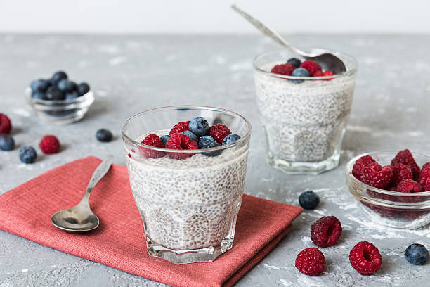 istock Healthy breakfast or morning with chia seeds vanilla pudding raspberry and blueberry berries on table background, vegetarian food, diet and health concept. Chia pudding with raspberry and blueberry 2250591331