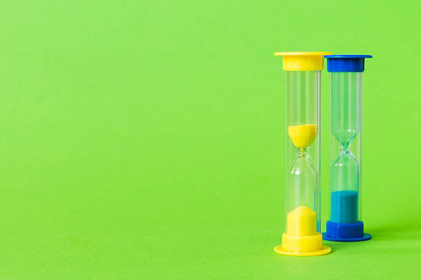 istock hourglass on the table, sand clock as time passing concept for business deadline, copy space 2250591358