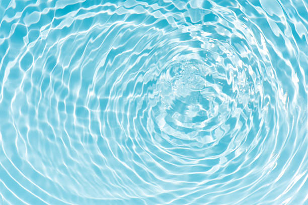 istock Blue water with ripples on the surface. Defocus blurred transparent blue colored clear calm water surface texture with splashes and bubbles. Water waves with shining pattern texture background. 2250591635