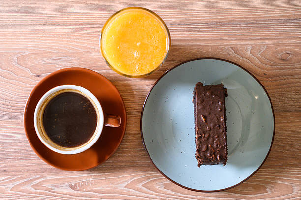 istock Coffee, orange juice, and chocolate cake for breakfast 2250594107