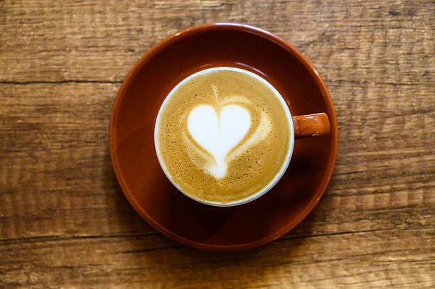 istock Coffee cup showing latte art heart on wooden table 2250600664