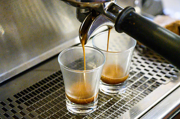 istock Espresso machine brewing double shot coffee into glasses 2250600940