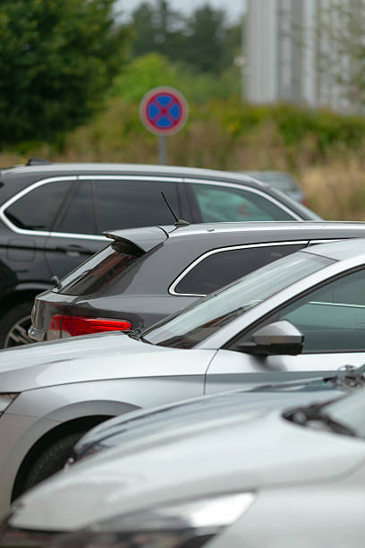 istock Manager reviews designated parking spaces as driver searches for spot 2250600996