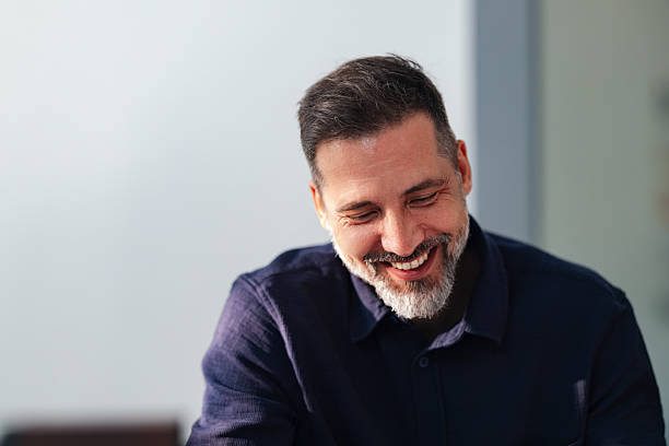istock Smiling Man in Navy Shirt Working Calmly in a Modern Office Coworking Space 2250601336