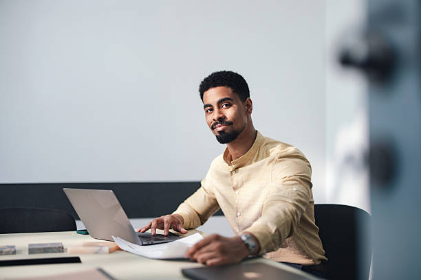 istock Professional Man Working at Laptop in Modern Office, Focused on Documents and Tasks 2250601427