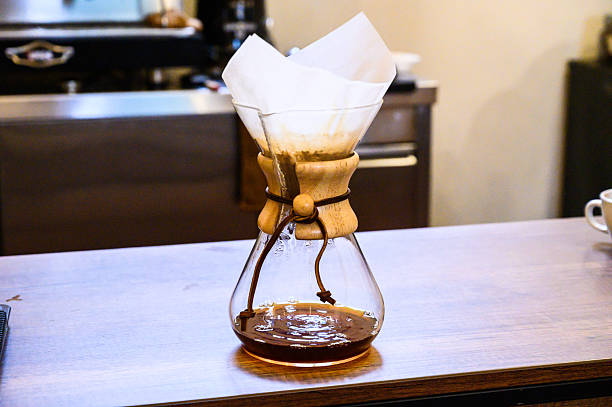 Chemex coffee dripper brewing fresh hot coffee in a cafe, a popular brewing method