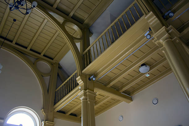 The beautiful hospital chapel hall with mezzanines, a wooden ceiling and cast iron columns