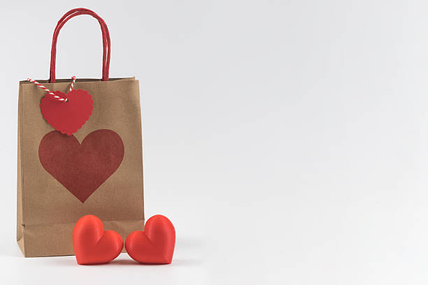 istock Gift bag with red heart on white background with copy space. 2250604018
