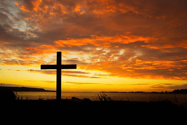 istock Christian Cross River Mouth Sunset Silhouette 2250609049