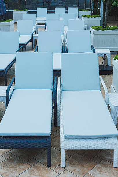 istock Deckchairs stand in a row near the pool, places for comfortable relaxation on deckchairs 2250611175