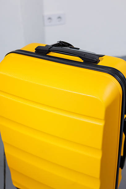 istock Yellow bright suitcase for tourist trips. High-quality yellow suitcase 2250614530