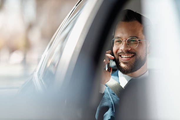 Businessman Talking on Phone Inside Car