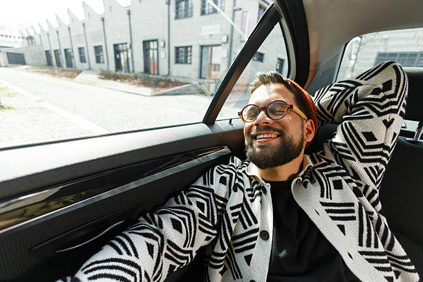 istock Cheerful Man Relaxing in Car Backseat 2250614573