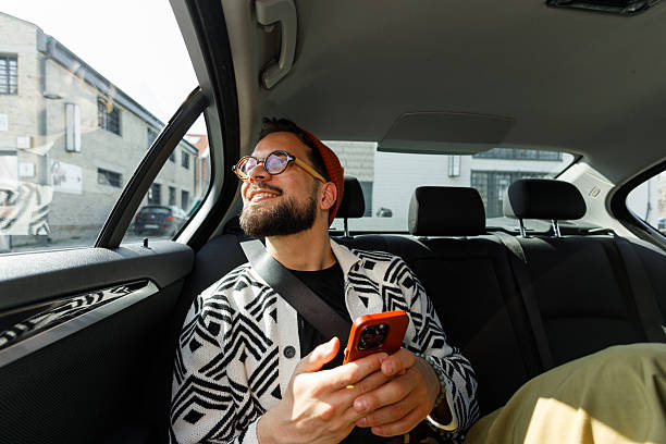 istock Man Having Video Call in Car Backseat 2250614579