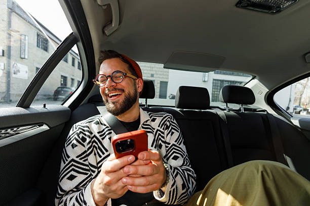 istock Man Having Video Call in Car Backseat 2250614587