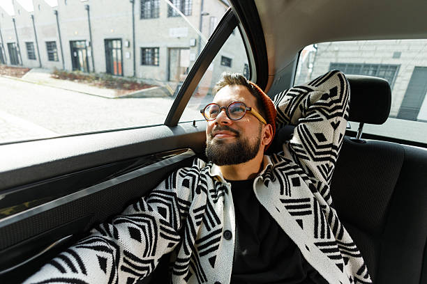 istock Cheerful Man Relaxing in Car Backseat 2250614589