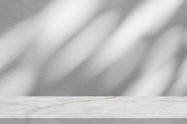 istock Marble table with tree shadow drop on white wall background for mockup product display 2250614808